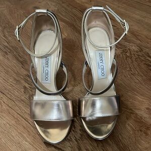 Jimmy Choo gold and silver metallic ankle strap sandals.